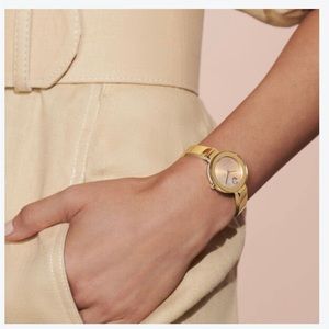 Movado luxury women’s watch with mother of pearl face and silver cuff wristband